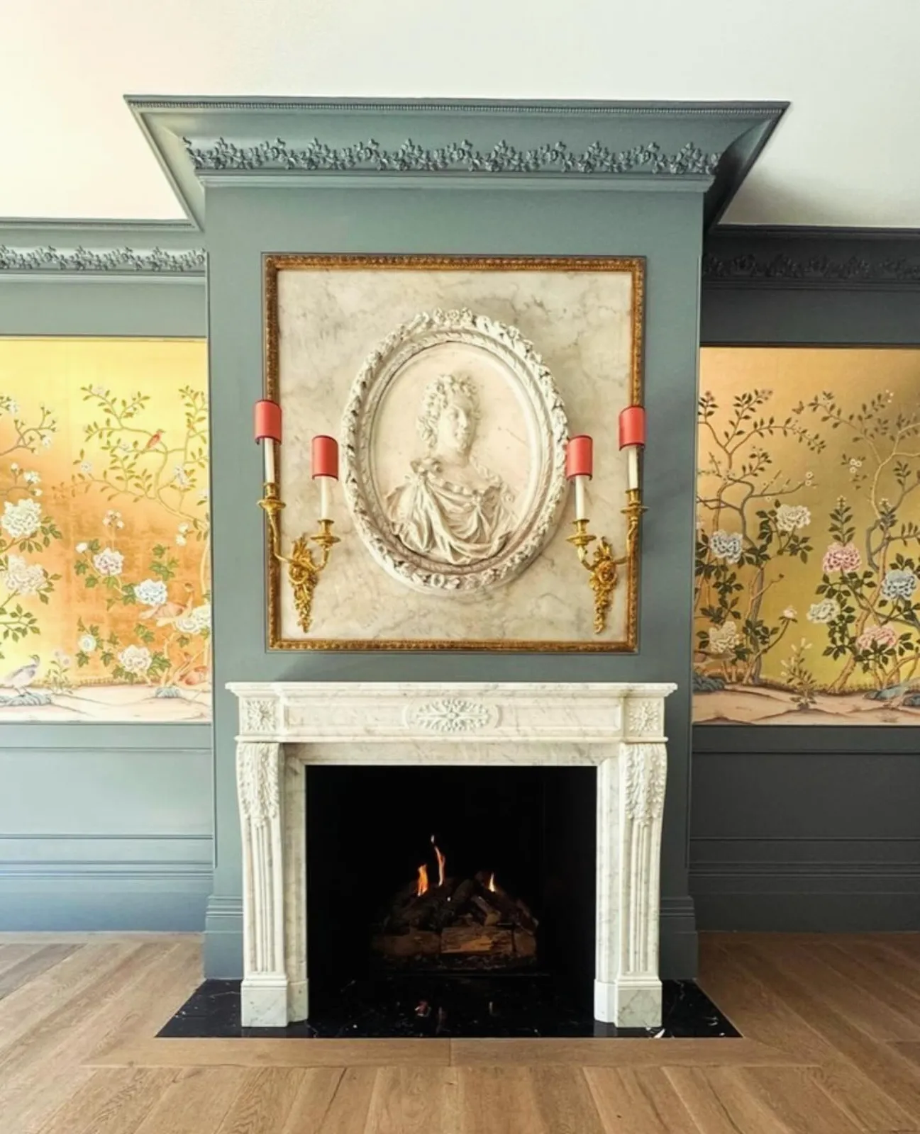 Louis XVI marble fireplace with chinoiserie wall panels, bas-relief portrait medallion and gilt brass sconces